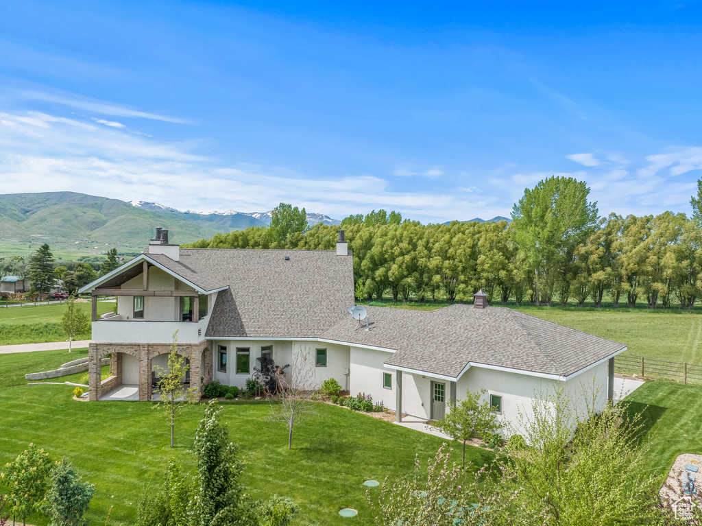 View of front facade featuring a front lawn and a mountain view