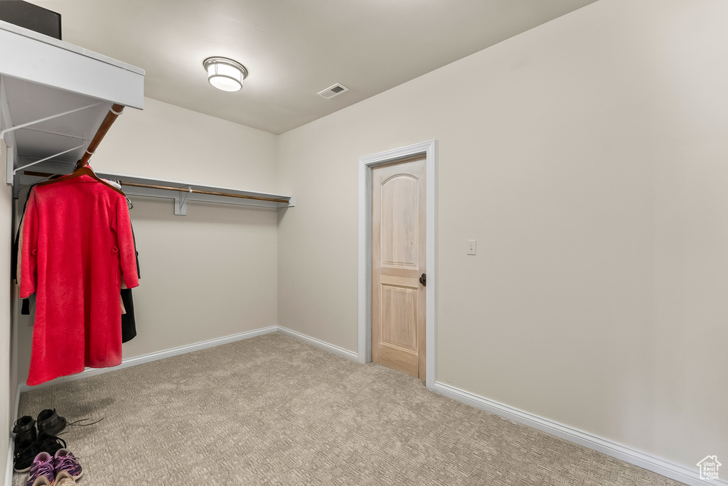 Walk in closet featuring carpet flooring