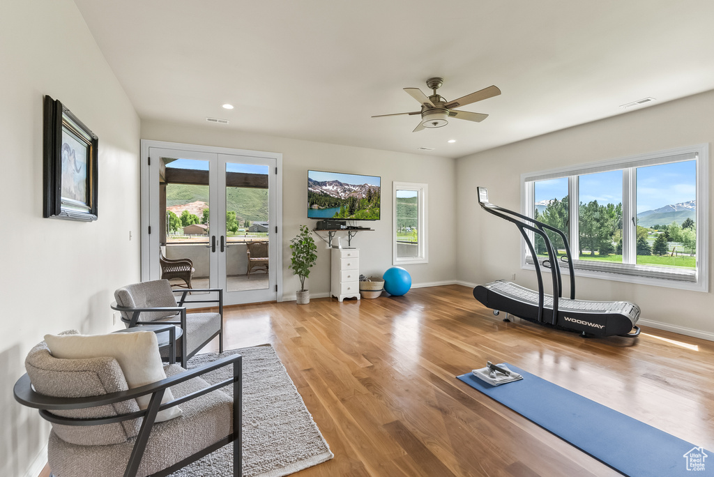 Exercise area with french doors, ceiling fan, and hardwood / wood-style floors