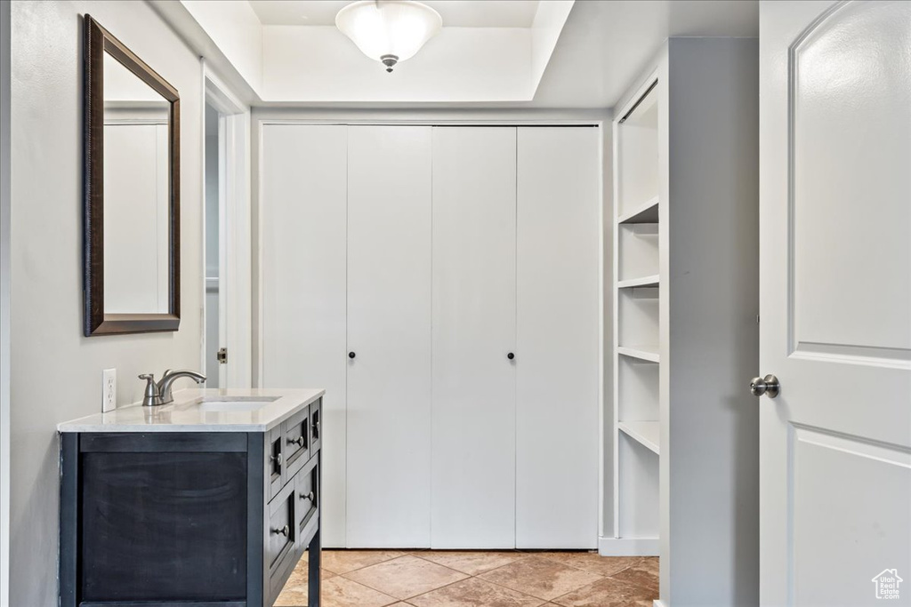 Bathroom featuring oversized vanity and tile floors