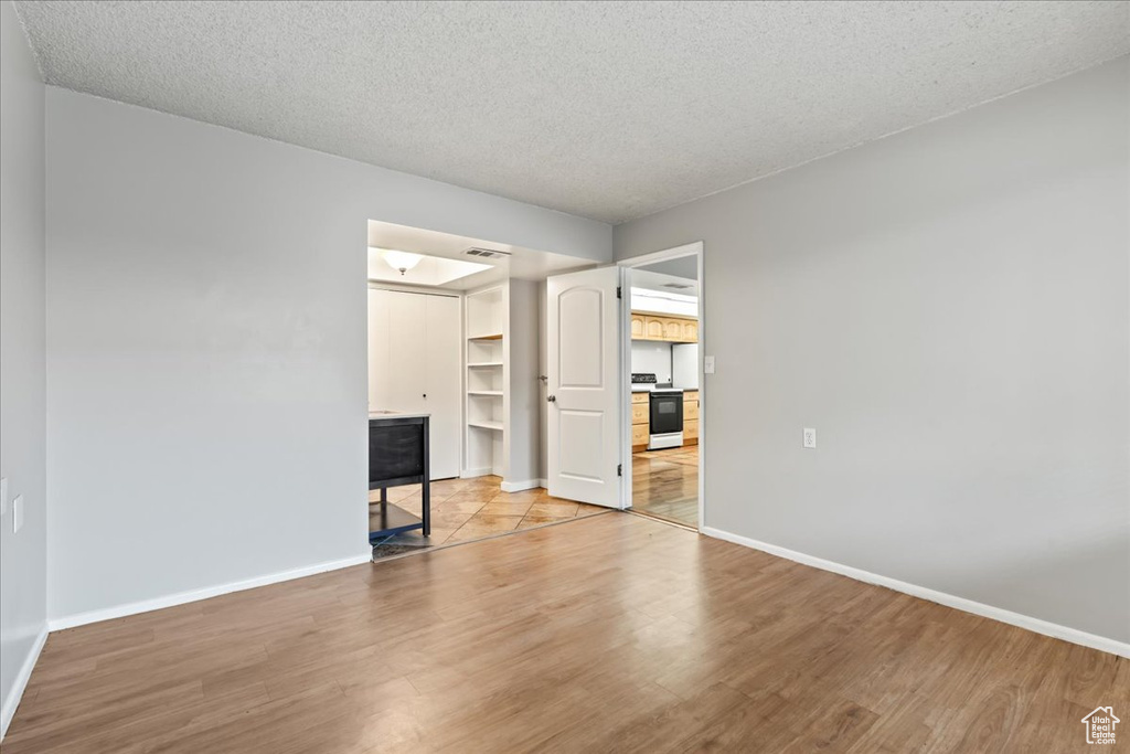 Interior space with a textured ceiling and light tile floors