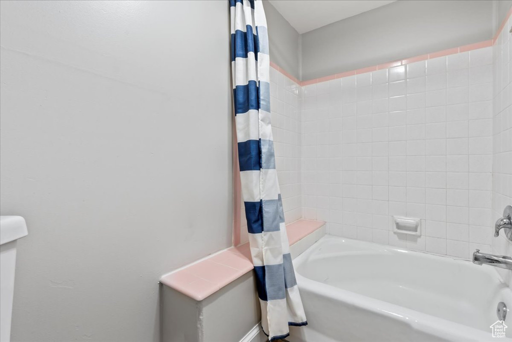 Bathroom featuring shower / bath combination with curtain