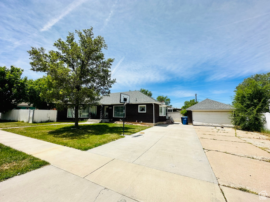 Ranch-style home featuring a front lawn