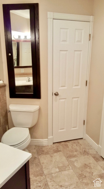 Bathroom with vanity, toilet, and tile floors