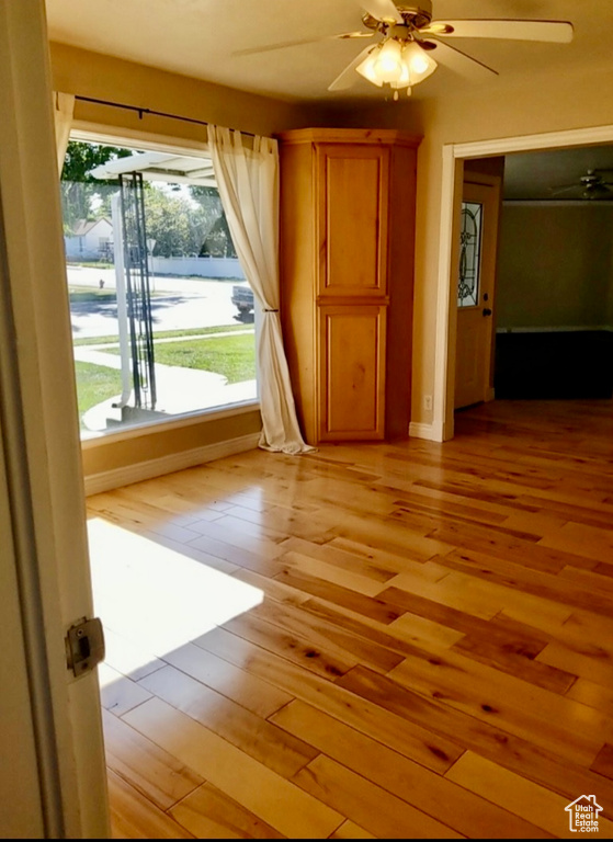 Spare room with hardwood / wood-style floors and ceiling fan