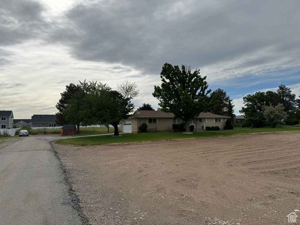 View of front of home featuring a front yard and a garage