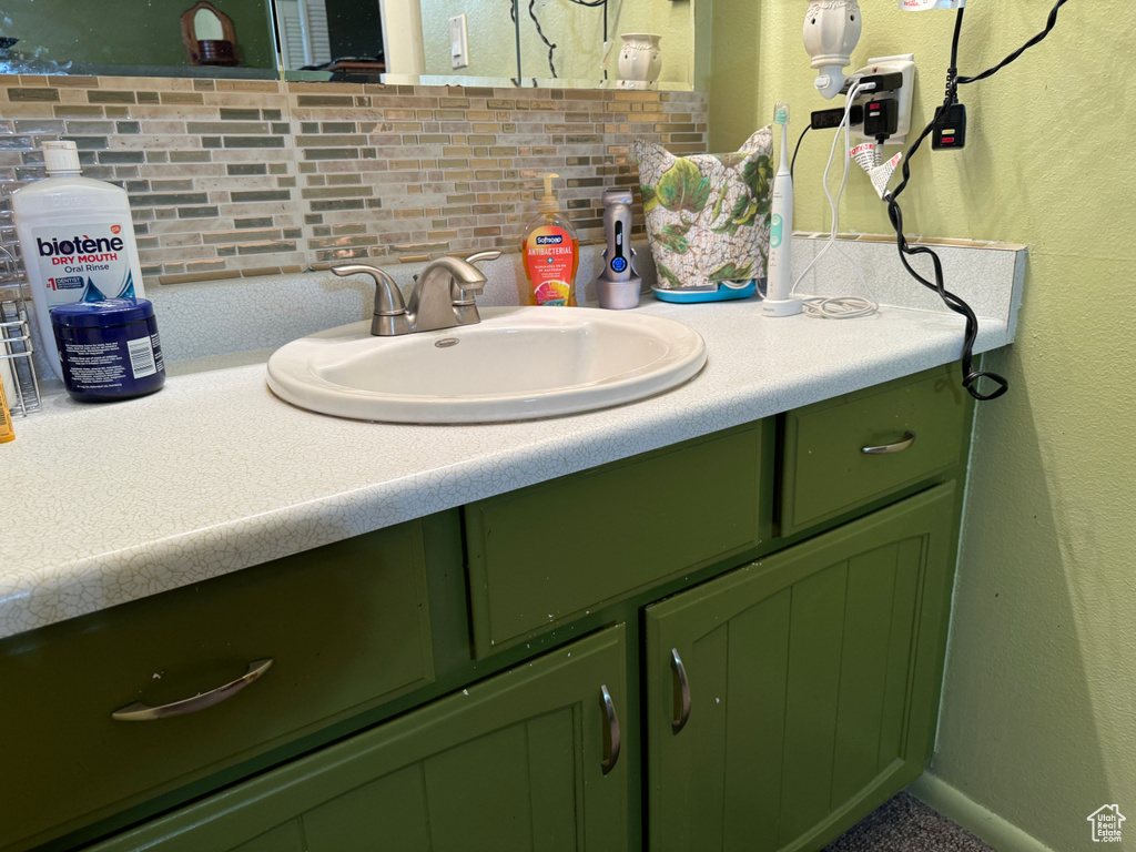 Bathroom featuring backsplash and vanity