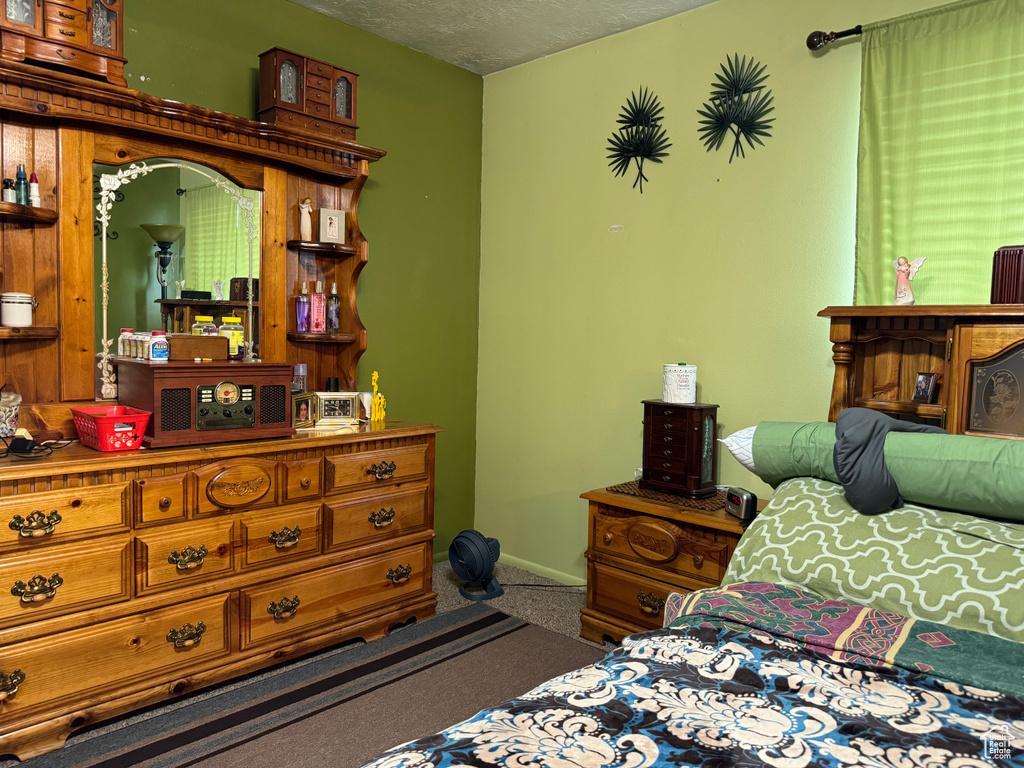 Carpeted bedroom with a textured ceiling