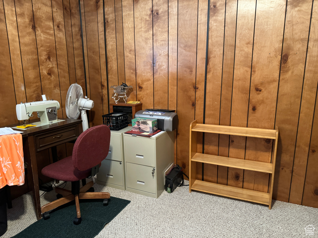 Home office featuring wood walls and carpet flooring