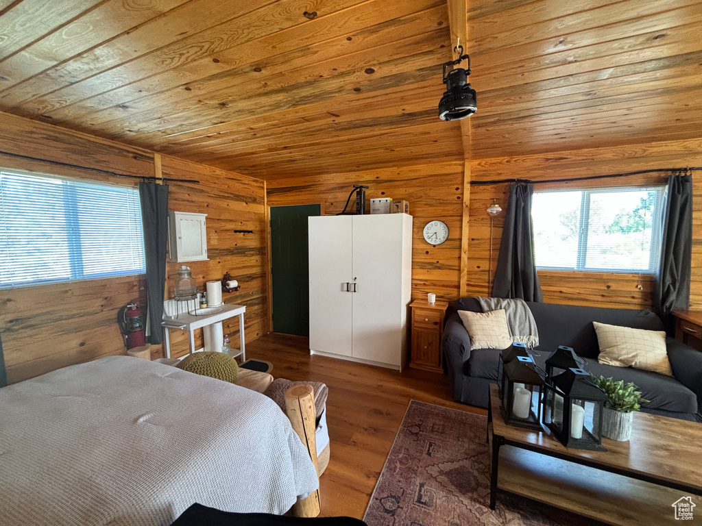 Bedroom with wood walls, wood ceiling, and wood-type flooring