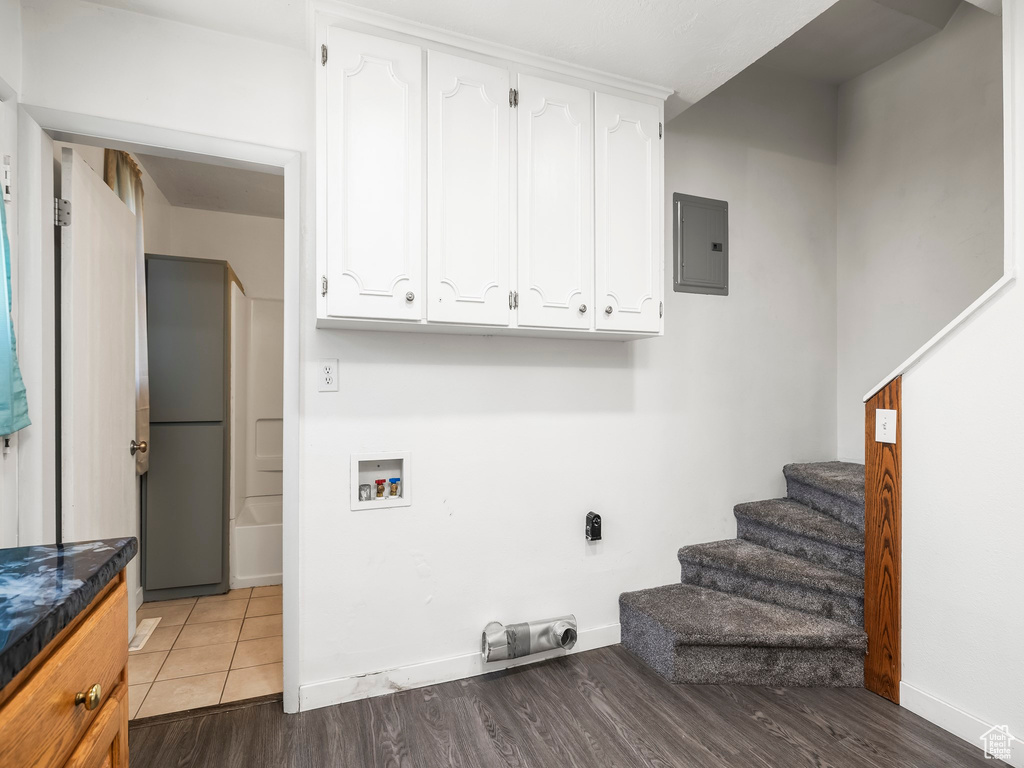 Laundry room with electric dryer hookup, tile flooring, and hookup for a washing machine