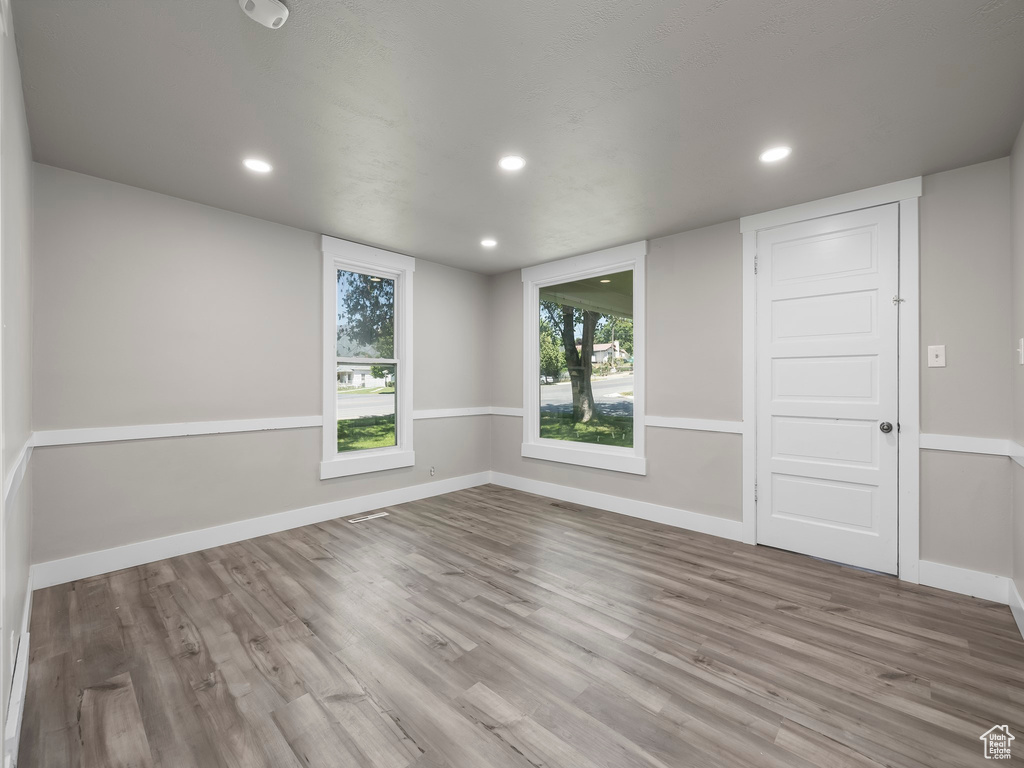 Empty room with hardwood / wood-style flooring