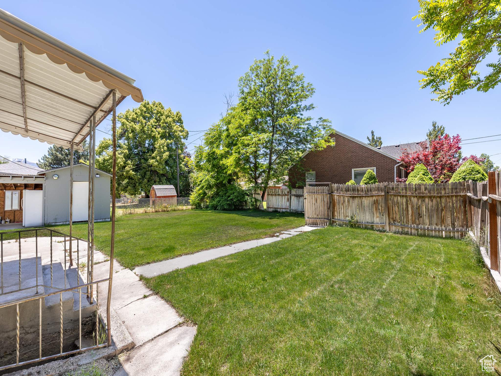 View of yard featuring a storage unit