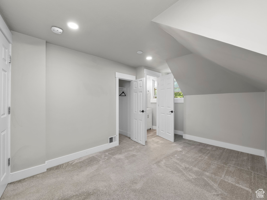 Bonus room featuring carpet and lofted ceiling