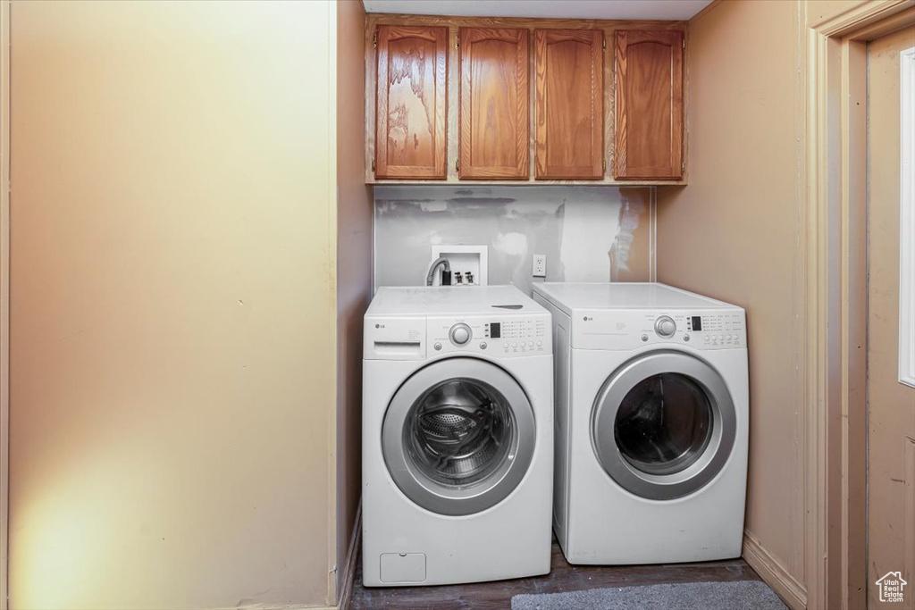 Washroom with cabinets, washing machine and dryer, and hookup for a washing machine