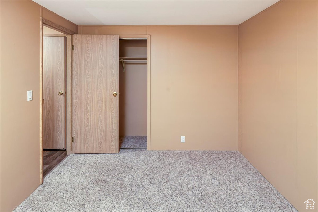 Unfurnished bedroom with a closet and carpet floors