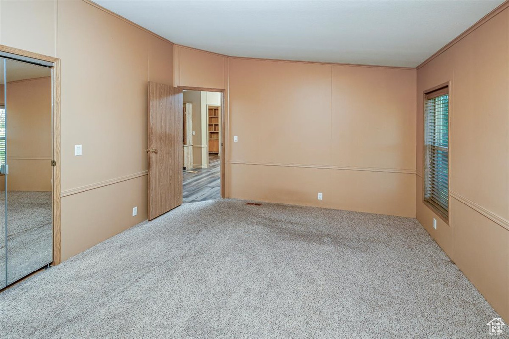 Unfurnished room featuring hardwood / wood-style floors and crown molding