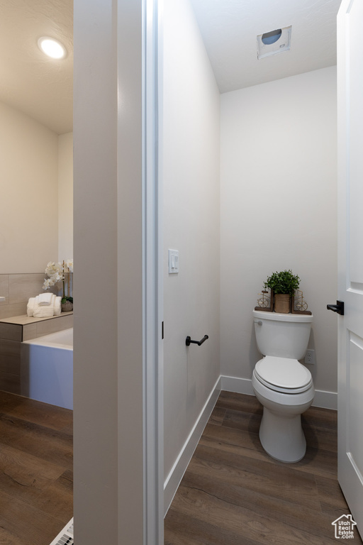 Bathroom featuring wood-type flooring and toilet