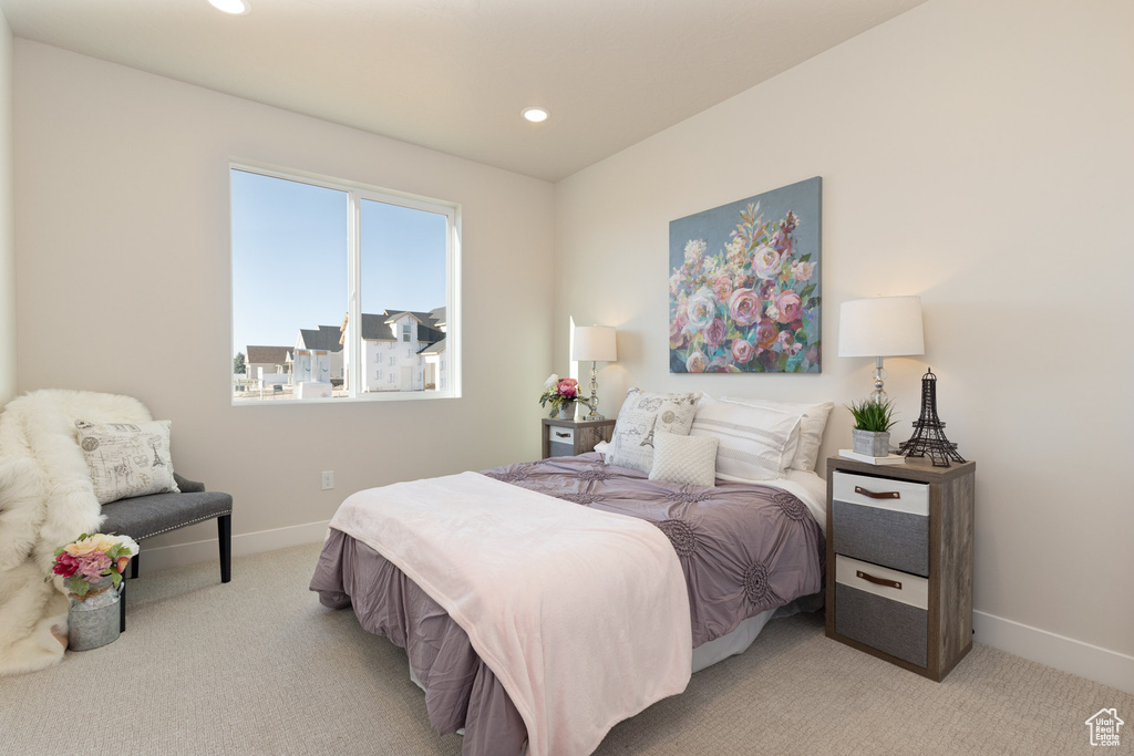 Bedroom featuring light carpet