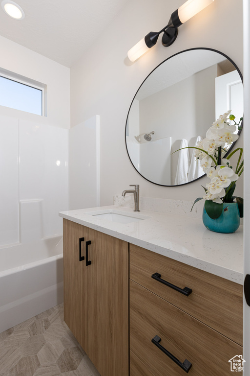 Bathroom featuring shower / bath combination, vanity, and tile patterned floors