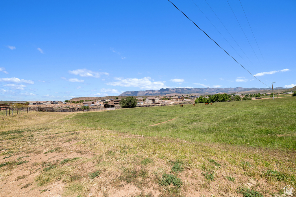 View of yard with a rural view and a mountain view