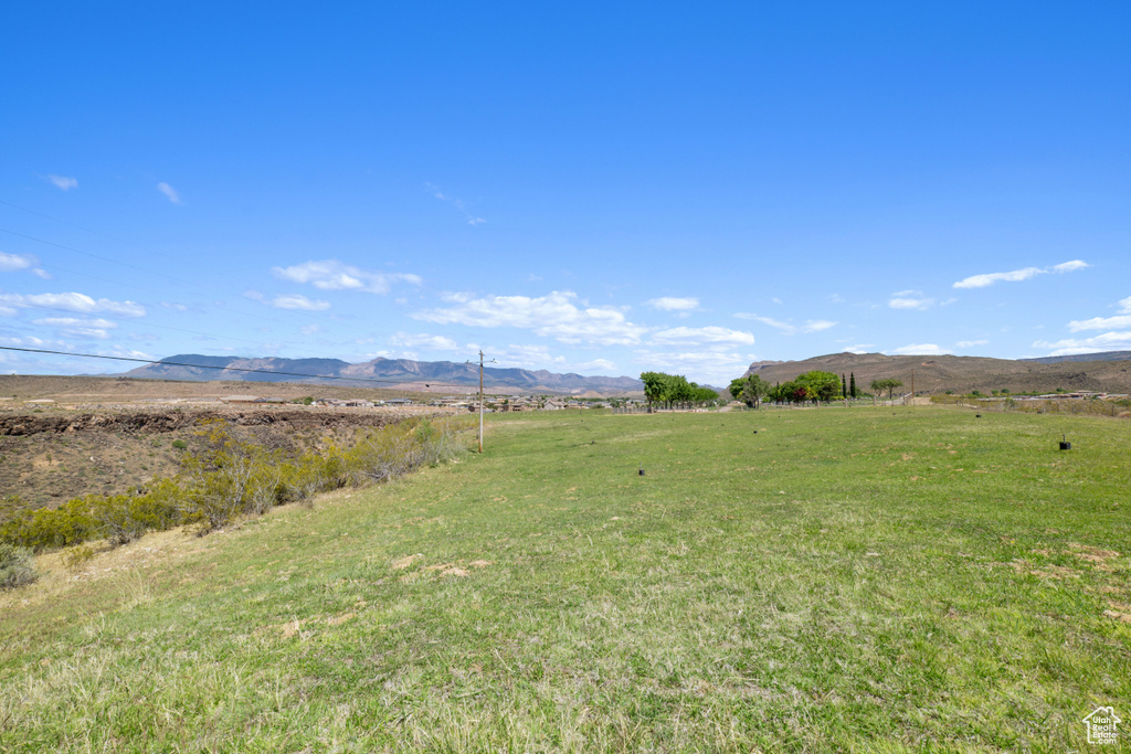 View of yard with a rural view and a mountain view