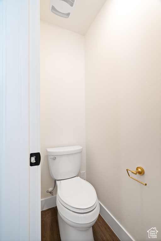 Bathroom featuring wood-type flooring and toilet