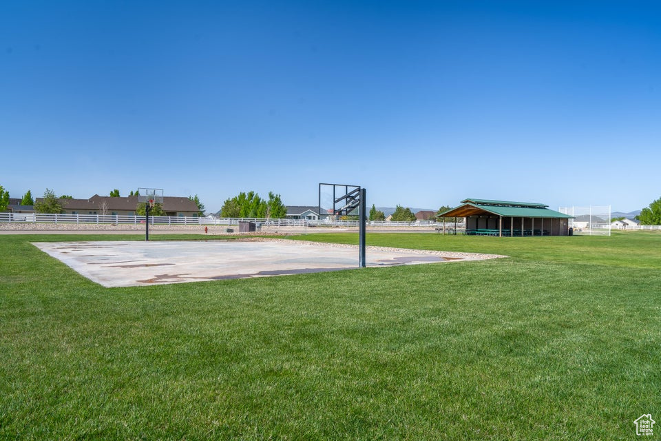 View of basketball court featuring a yard