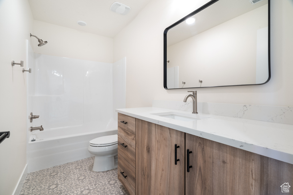 Full bathroom featuring vanity, toilet, and bathing tub / shower combination