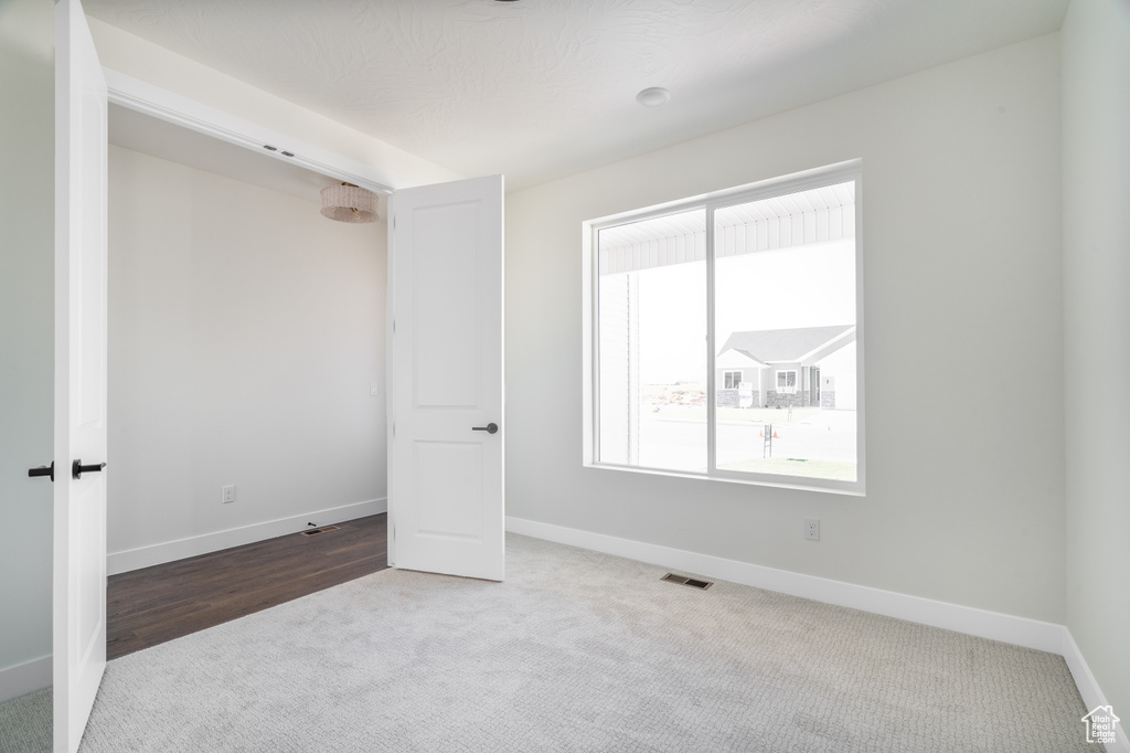 Unfurnished room with carpet