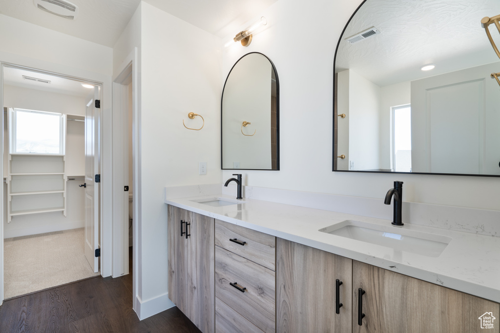 Bathroom with vanity and hardwood / wood-style flooring