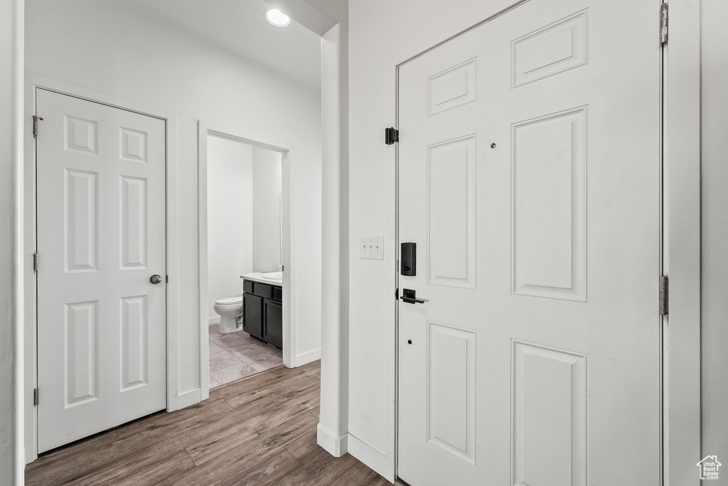 Hallway with light hardwood / wood-style floors