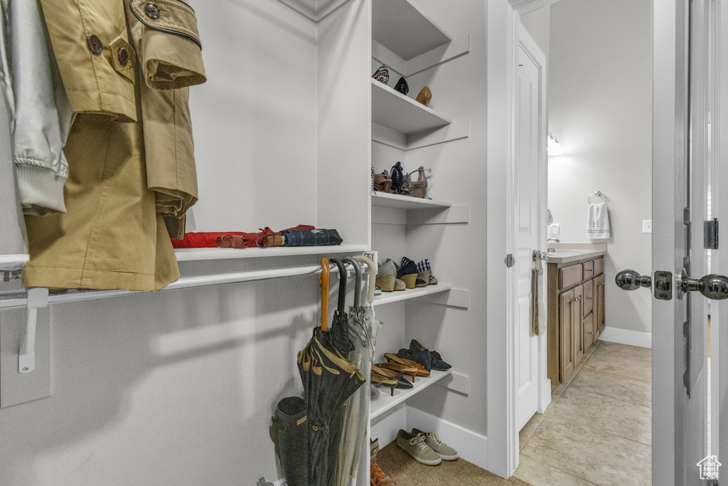 Spacious closet with light tile flooring