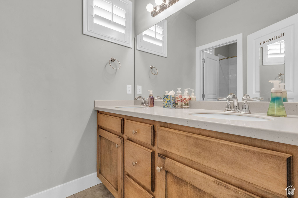 Bathroom with tile flooring and double vanity