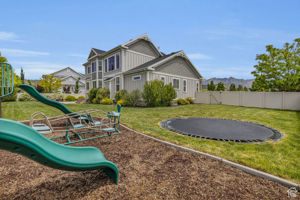 Exterior space featuring a playground and a trampoline