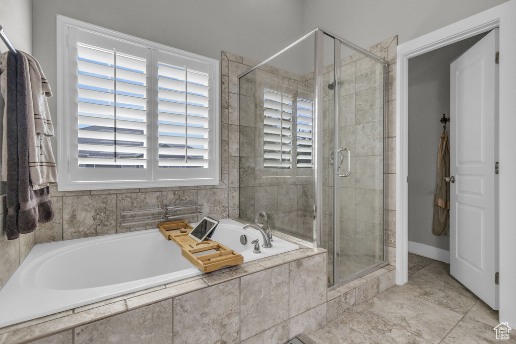 Bathroom featuring tile flooring and separate shower and tub