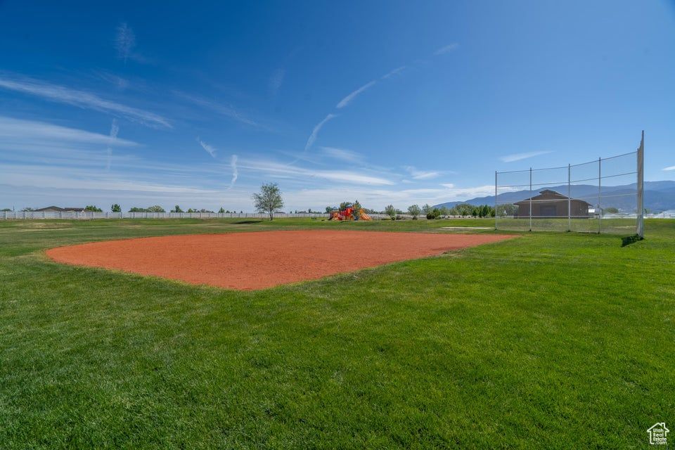 View of nearby features featuring a yard and a mountain view