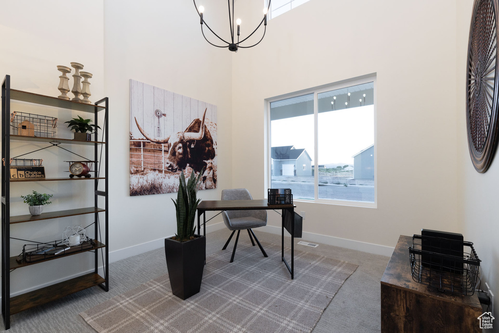 Carpeted office with a notable chandelier