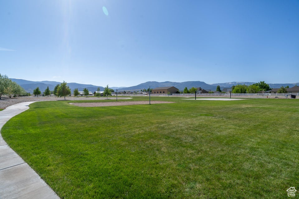 View of nearby features featuring a mountain view and a lawn