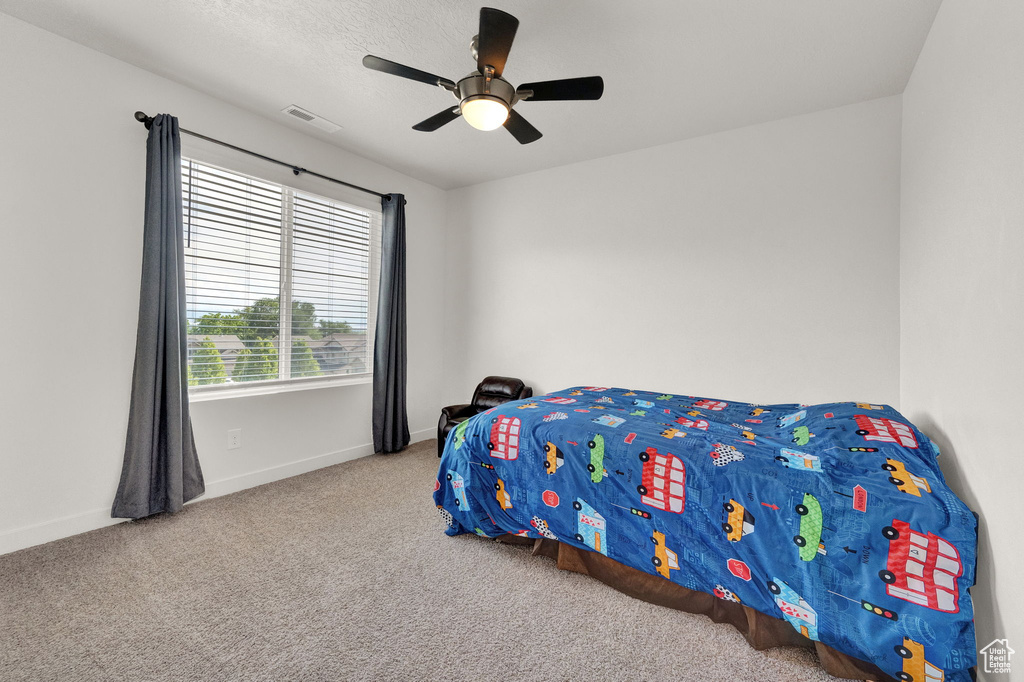 Bedroom with carpet flooring and ceiling fan