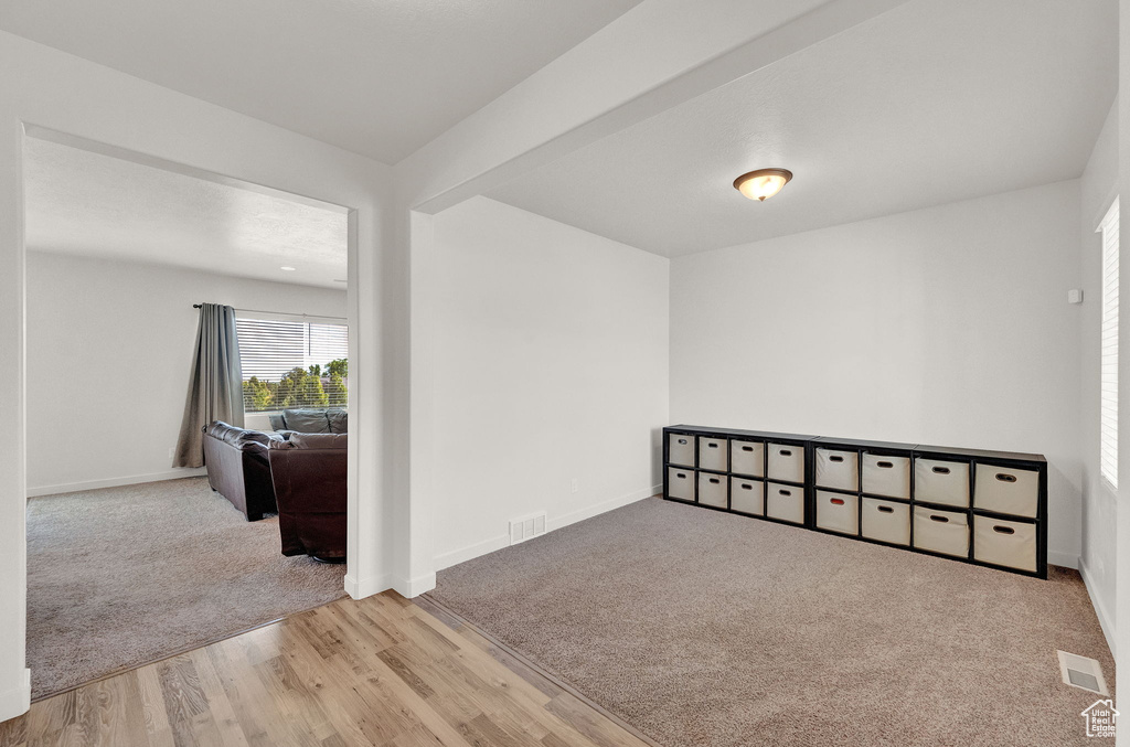 Empty room with light hardwood / wood-style floors