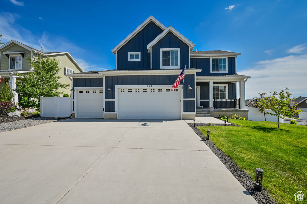 View of front of house featuring a garage and a front lawn