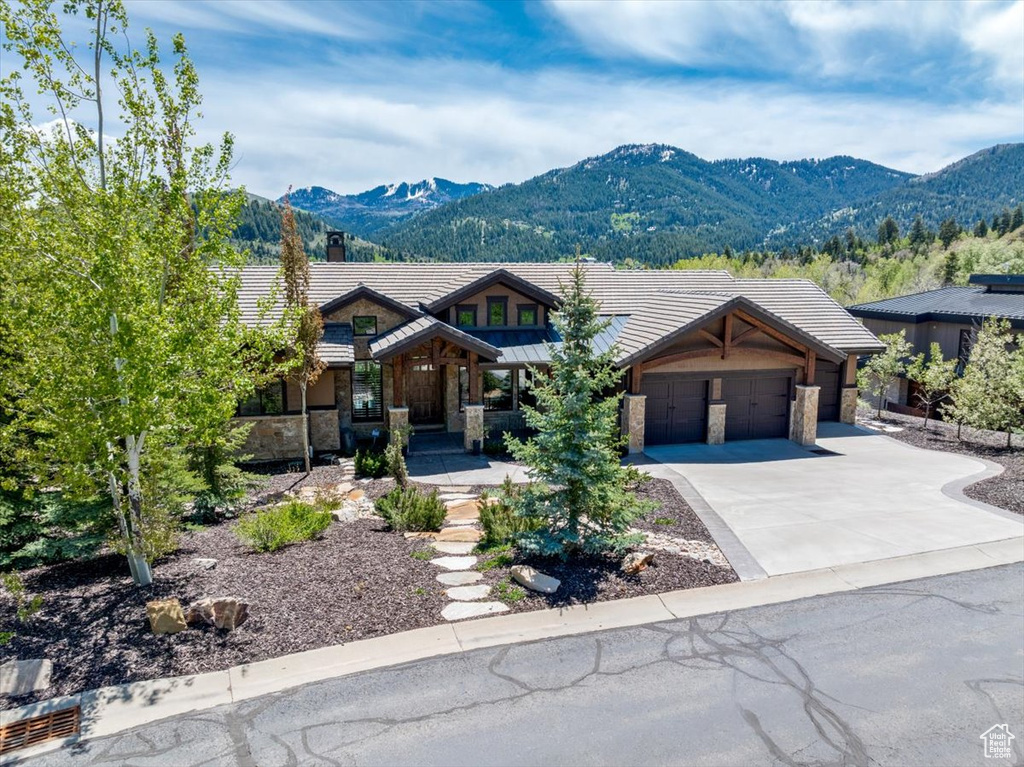 View of front of property featuring a garage and a mountain view