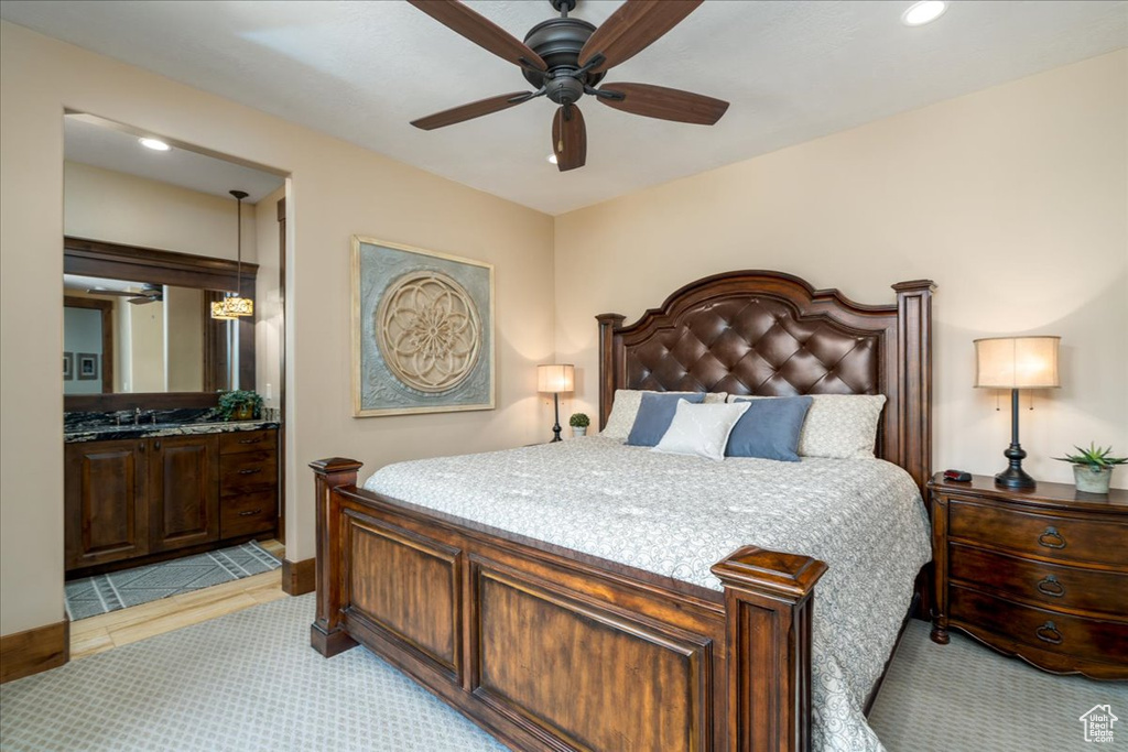 Tiled bedroom featuring ceiling fan and sink