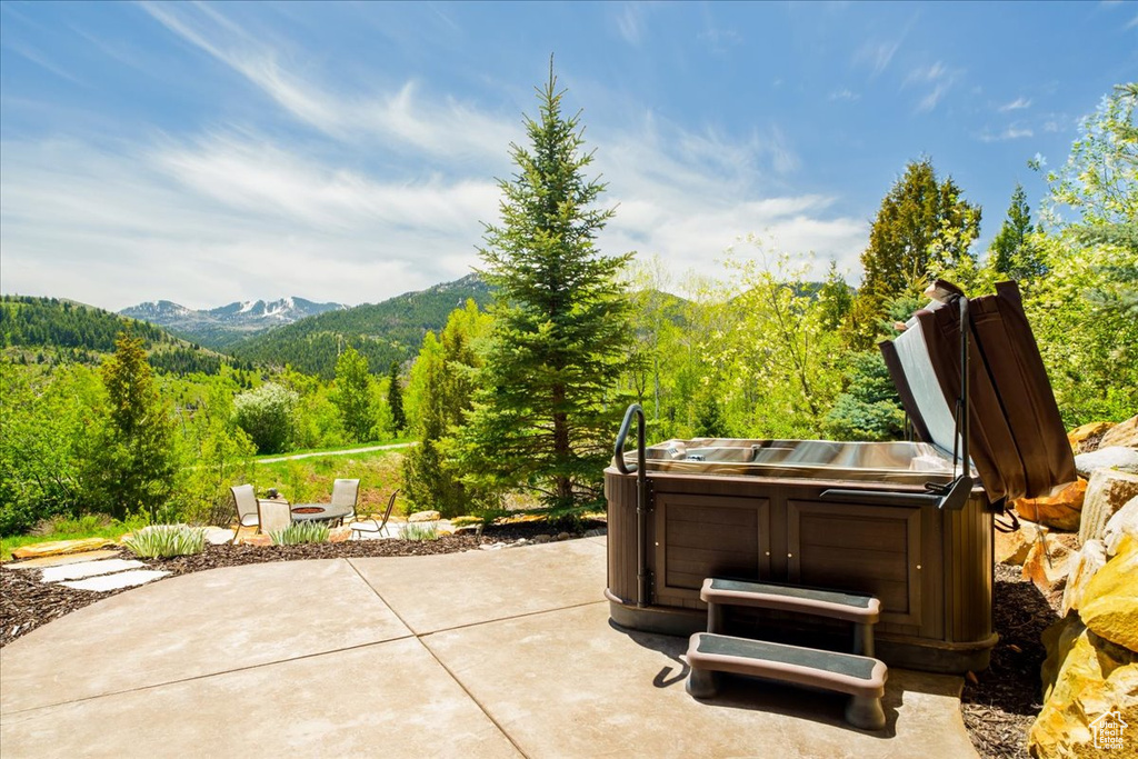 View of terrace featuring a mountain view and a hot tub