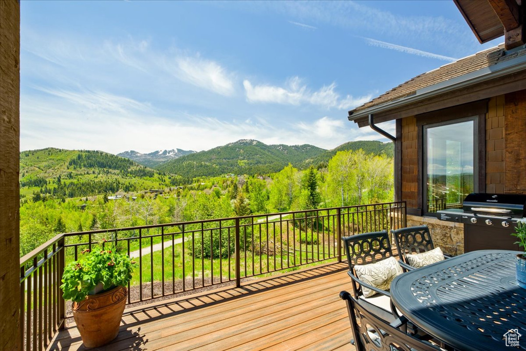 Deck with a mountain view and a grill