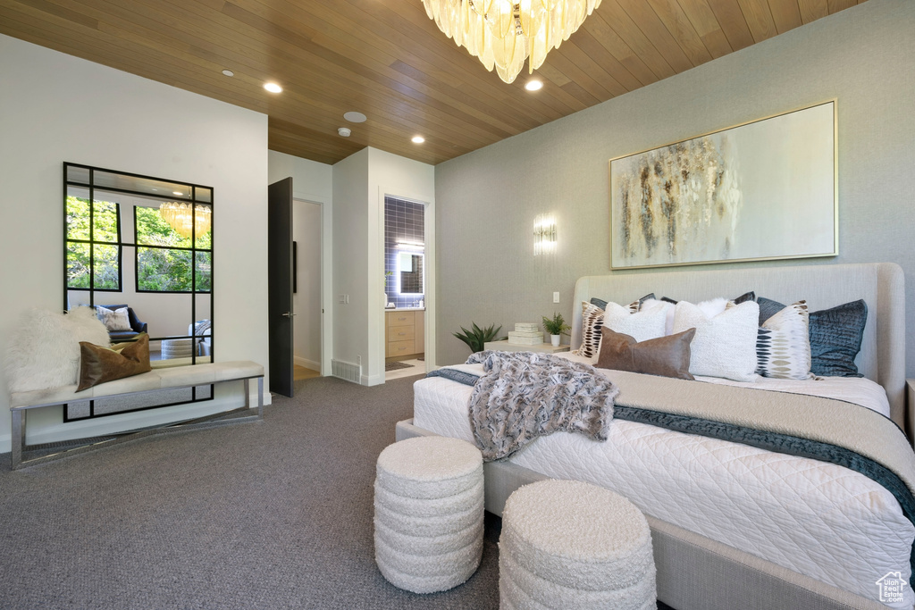 Bedroom featuring a chandelier, connected bathroom, wood ceiling, and carpet flooring