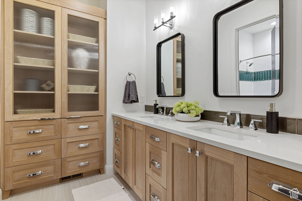 Bathroom featuring tile flooring and dual bowl vanity