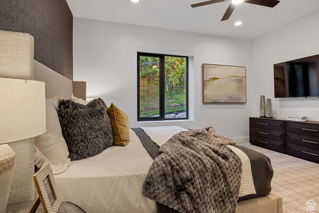 Carpeted bedroom with ceiling fan