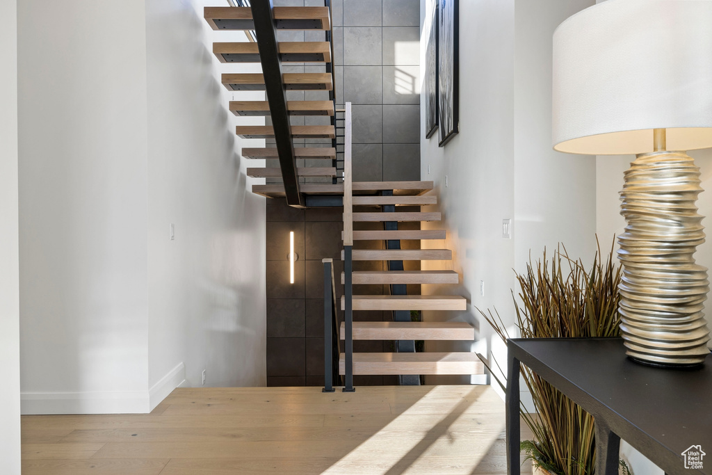 Stairway featuring hardwood / wood-style floors